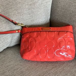 Coach apricot patent wristlet
